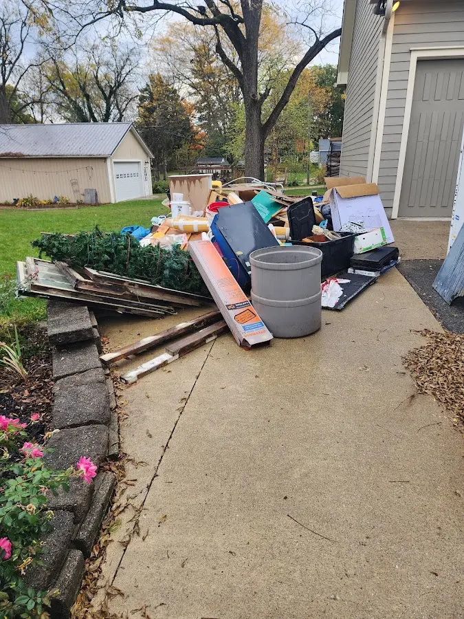 Dumpster being loaded with debris for Estate Cleanout Dumpster Rental in North Fort Myers
